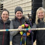 Picture of Sport Positive Founder, Jerri Gillean, posing with her friends, dog Jackie & PACH bar & ribbon.